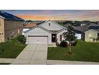 Charming single-Gathering home features a well-manicured lawn and attached two-car garage at 356 Nova Dr, Davenport, FL 33837