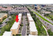 An aerial view displays the townhome community, lined with palm trees and manicured green spaces, near main thoroughfare at 4816 Tidecrest Ave # 178, Orlando, FL 32819