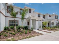 Charming townhome exterior with lush landscaping and a welcoming covered front porch at 4834 Lullaby Ln, Kissimmee, FL 34746