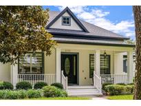 Charming single-Gathering home featuring a welcoming front porch and well-manicured landscaping at 11721 Camden Park Dr, Windermere, FL 34786