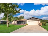 Charming single-story home with a spacious front yard and screened patio at 1242 Liza St, St Cloud, FL 34771