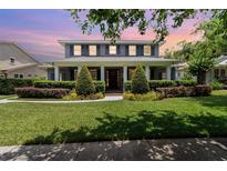 Charming two-story home with a manicured lawn and landscaped garden beds at 1355 Hibiscus Ave, Winter Park, FL 32789