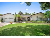Charming single-story home with a well-manicured lawn, beautiful landscaping, and a welcoming front entrance at 2020 Geronimo Trl, Maitland, FL 32751