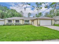 Charming single-story home featuring a well-manicured lawn and a two-car garage at 320 Bridle Path, Casselberry, FL 32707