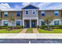 Attractive townhome exterior featuring a landscaped yard and inviting entryway at 322 Annabelle Way, Davenport, FL 33837