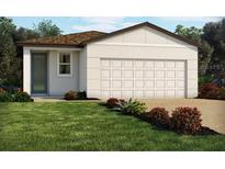 Charming single-story home with a well-manicured lawn and a large two car garage at 4993 Kaia Ave, Winter Haven, FL 33884