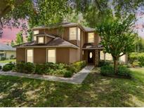 Charming two-story home featuring a manicured lawn and inviting front entrance at 556 Lake Ave, Altamonte Springs, FL 32701