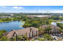Scenic aerial view of lakeside apartment buildings with views of ICON Park and the Orlando skyline at 8801 Latrec Ave # 8107, Orlando, FL 32819