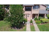 Charming townhome featuring a welcoming entrance with lovely landscaping and a decorative wreath at 105 Wood Duck Cir # D, Daytona Beach, FL 32119