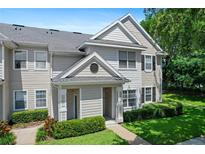 Charming two-story townhome with manicured lawn and inviting entrance at 1300 Eastern Pecan Pl # 104, Winter Garden, FL 34787
