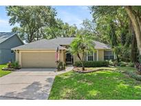 Charming single-story home with an attached garage, well-maintained lawn and appealing landscaping features at 1354 Dutch Elm Dr, Altamonte Springs, FL 32714