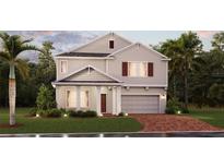 Charming two-story home with a welcoming front porch, attached garage, and beautifully landscaped front yard at 1851 Blissful Dr, Kissimmee, FL 34744