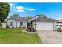 Charming single-story home with attached garage, inviting front yard, and well-maintained landscaping at 2916 Maldive Ct, Deltona, FL 32738
