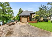 Charming home with a well-maintained front yard and cozy seating overlooking the adjacent lake at 3501 Danby Ct, Orlando, FL 32812