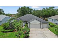 Charming single-story home boasts a well-manicured lawn, mature landscaping, and a three-car garage for ample parking at 468 Alinole Loop, Lake Mary, FL 32746