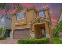 Inviting two-story home featuring a brick driveway, two-car garage, and a meticulously maintained lawn at 531 Lasso Dr, Kissimmee, FL 34747