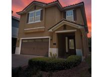 Charming two-story home with a tile roof, an attached two-car garage, and a manicured front yard at 531 Lasso Dr, Kissimmee, FL 34747