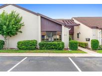 Exterior view of P-6 unit featuring clean landscaping and adjacent parking spaces at 101 Grand Plaza Dr # P6, Orange City, FL 32763