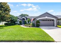 Charming single-story home with lush landscaping and a well-manicured front yard at 14377 Lord Barclay Dr, Orlando, FL 32837