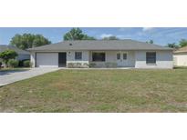 Charming single-story home with a well-manicured lawn and attached one car garage at 1668 Fort Smith Blvd, Deltona, FL 32725