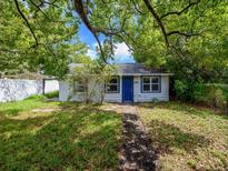 Charming single-story home featuring a blue front door, lush greenery, and well-maintained lawn at 1979 Staunton Ave, Winter Park, FL 32789