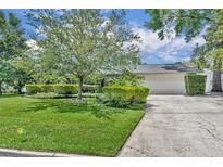 Charming single-story home with a well-manicured lawn, mature trees, and a two-car garage at 2081 Mohican Trl, Maitland, FL 32751