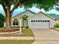 Charming single-Gathering home featuring a well-maintained lawn and attached two-car garage at 3055 Dellcrest Pl, Lake Mary, FL 32746