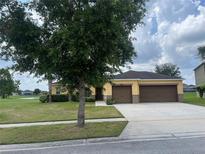Charming single-story home featuring a well-manicured lawn and a spacious three-car garage at 3651 Sail Harbor Dr, Kissimmee, FL 34746