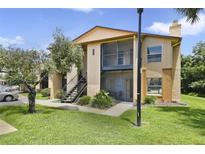 Inviting two-story condo featuring a screened balcony and well-maintained landscaping at 4870 S Semoran Blvd # 1905, Orlando, FL 32822