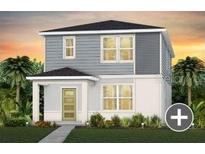Charming two-story home featuring gray siding, a welcoming front porch, and lush landscaping at 5027 Starling Bird Ln, St Cloud, FL 34771