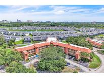Stunning aerial view of condo complex with landscaping, parking and nearby community at 6337 Parc Corniche Dr # 2312, Orlando, FL 32821