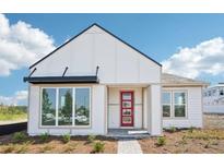 Modern home featuring a crisp white exterior, black awning, and a vibrant red front door at 6723 Sherpa Trl, St Cloud, FL 34771