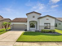 Charming single-Gathering home features a well-manicured lawn and attached two-car garage at 921 Costa Mesa Ln, Kissimmee, FL 34744