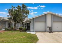 Charming single-story home featuring a well-maintained lawn, covered entry and attached two-car garage at 10438 Sw 85Th Ct, Ocala, FL 34481