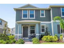 Charming two-story townhome with covered porch and well-maintained landscaping, providing excellent curb appeal at 13452 Sagestone Dr, Winter Garden, FL 34787