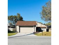 Inviting single-Gathering home featuring a two-car garage and manicured lawn at 1422 Spalding Rd, Winter Springs, FL 32708