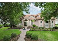 Charming home featuring a brick walkway, stone accents, well-maintained lawn, and mature landscaping at 1453 Langham Ter, Lake Mary, FL 32746