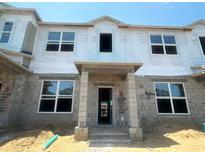 Unfinished townhome showing framing and windows with building wrap at 15382 Burgtheater Dr, Winter Garden, FL 34787