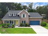 Charming two-story brick home with a well-manicured lawn, blue accents, and a welcoming yellow front door at 1610 Owl Ridge Ct, Apopka, FL 32712