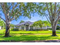 Charming single-story home boasts lush landscaping, mature trees, and inviting curb appeal at 2538 Carter Grove Cir, Windermere, FL 34786