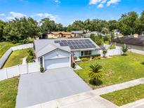 Charming single-story home featuring a solar panel roof, well-manicured lawn, and attached two-car garage at 2832 Buccaneer Dr, Winter Park, FL 32792
