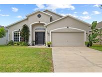 Charming single-story home with a well-maintained lawn and a two-car garage at 298 Clydesdale Cir, Sanford, FL 32773