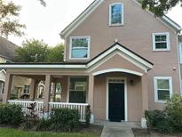Charming two-story home featuring a covered front porch and manicured landscaping, enhancing its curb appeal at 3417 Westchester Square Blvd # 202, Orlando, FL 32835