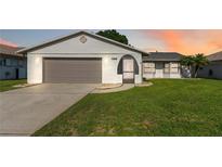 Charming single-story home features a two-car garage and a well-maintained lawn at 11412 Stamfield Dr, Orlando, FL 32821
