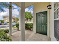 Inviting condo front door with classic design elements and number, framed by columns and lush landscaping at 141 Reserve Cir # 113, Oviedo, FL 32765