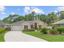 Charming one-story home with a well-manicured lawn, lush landscaping, and a cozy entrance at 3593 Scoutoak Loop, Oviedo, FL 32765