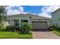 Charming single-story home with a well-manicured lawn and a welcoming two-car garage, fronted by a brick driveway at 5081 Twin Lakes Blvd, St Cloud, FL 34772