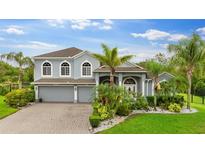 Beautiful two-story home featuring a well-manicured lawn and a three-car garage, blending luxury with curb appeal at 6234 Tremayne Dr, Mount Dora, FL 32757