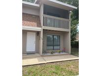 Charming two-story home with a private balcony, decorative flower bed, and a welcoming front entrance at 752 Howland Ln # 114, Altamonte Springs, FL 32701