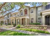 Charming townhomes with landscaped front yards and inviting front porches at 7715 Anselmo Ln, Windermere, FL 34786